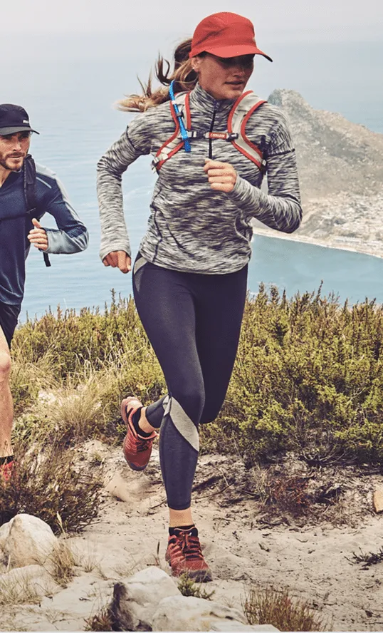 Woman trail running in a grey marl top and leggings